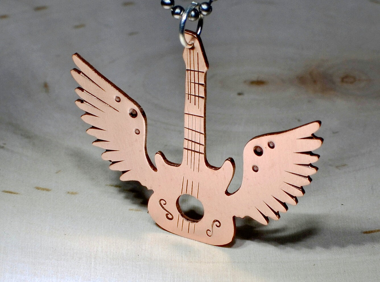 Copper winged guitar necklace