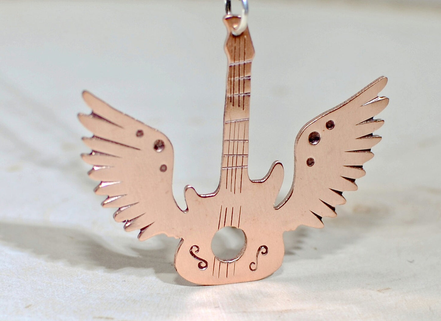 Copper winged guitar necklace