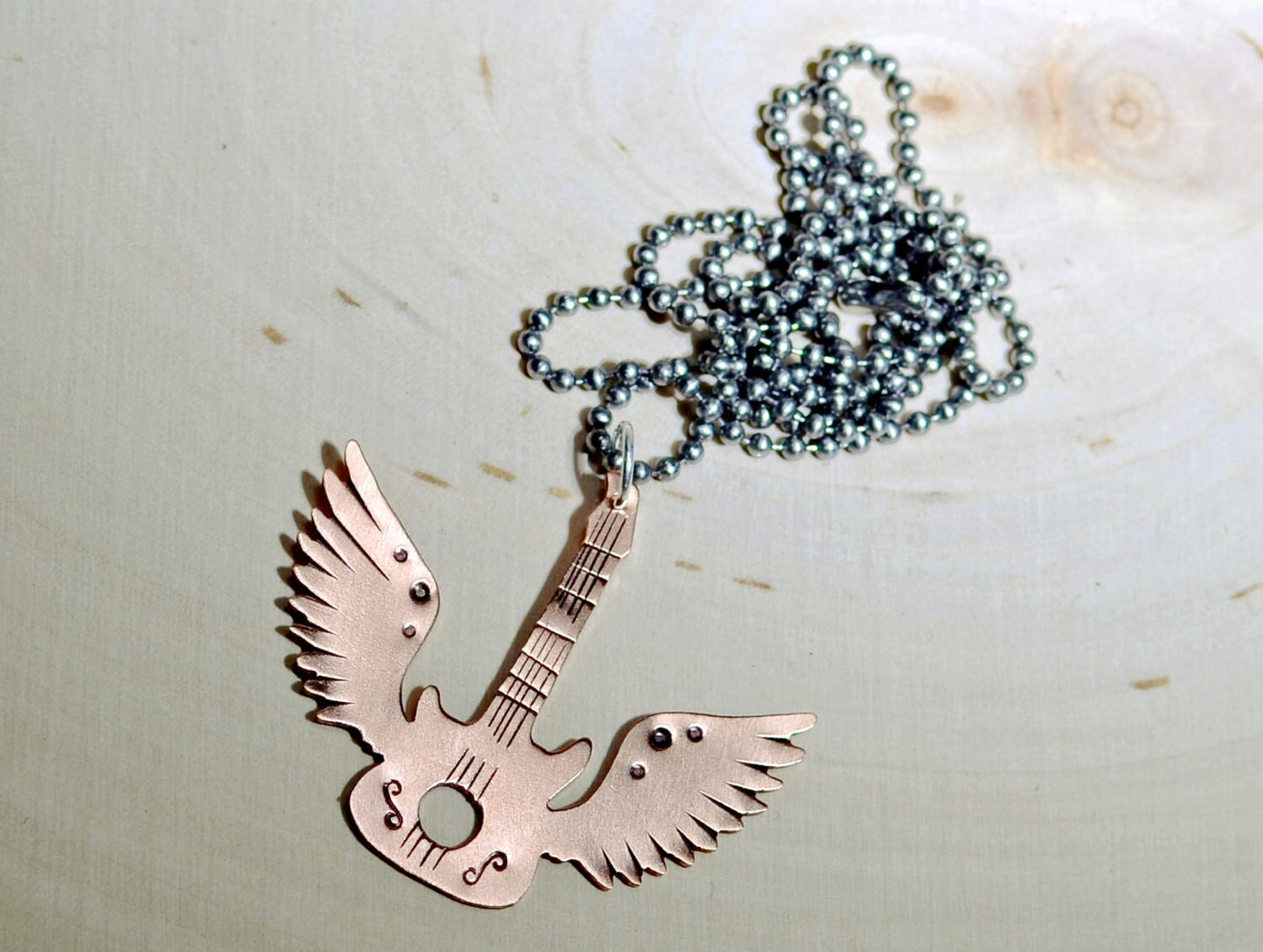 Copper winged guitar necklace