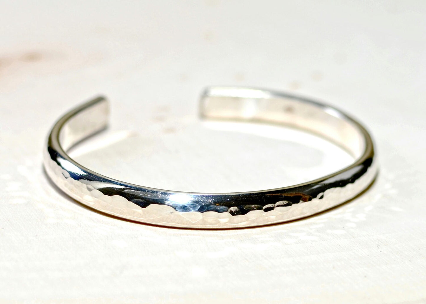 Sterling silver half round bracelet with hammered texture and mirror finish