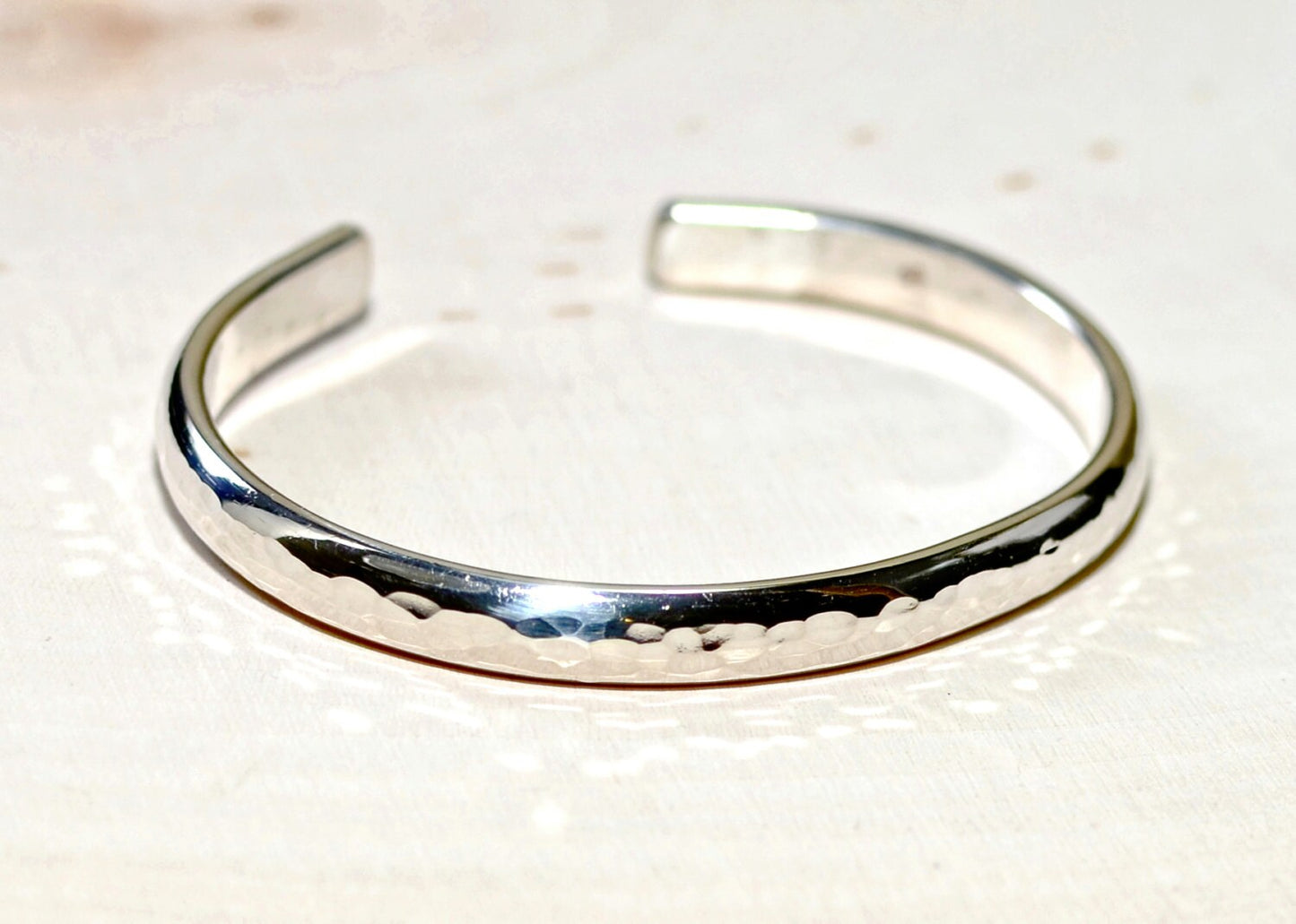 Sterling silver half round bracelet with hammered texture and mirror finish