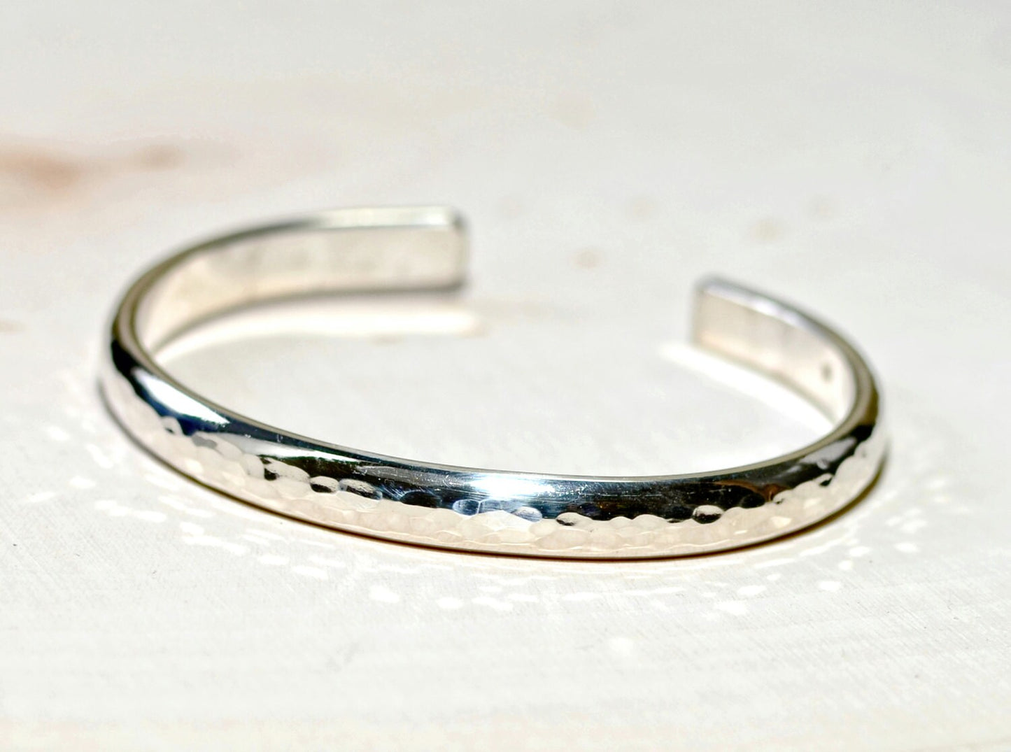 Sterling silver half round bracelet with hammered texture and mirror finish