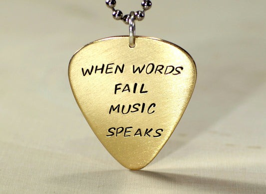 When words fail music speaks on a 14K solid yellow gold guitar pick necklace