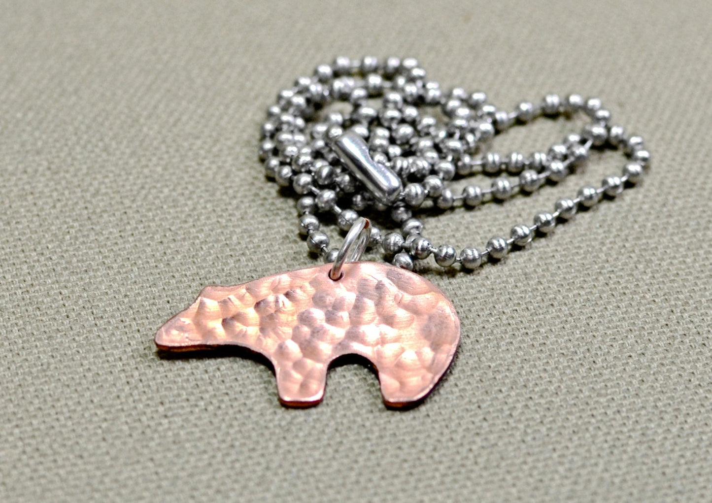 Spirit bear copper necklace with hammered and swirl texture