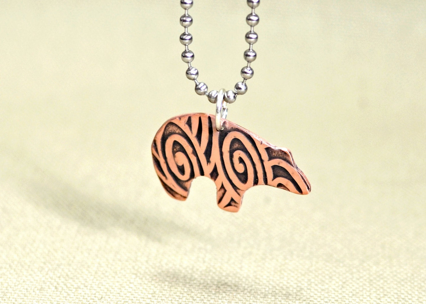 Spirit bear copper necklace with hammered and swirl texture