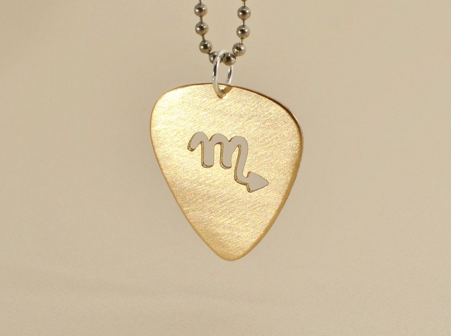 Zodiac guitar pick necklace series with cutout designs