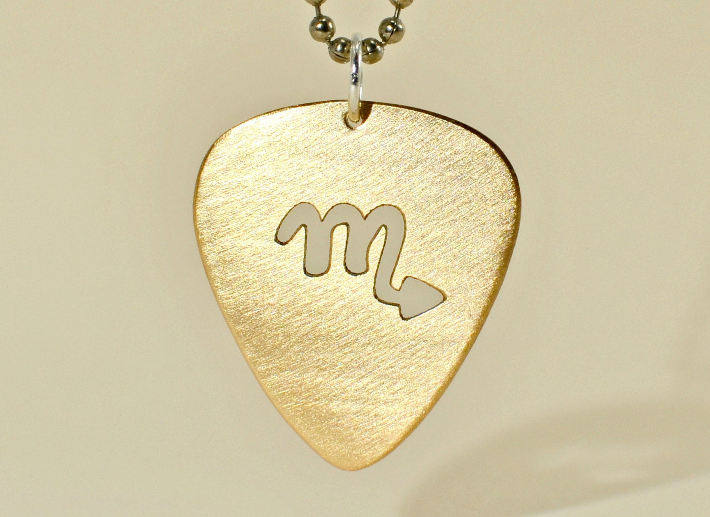 Zodiac guitar pick necklace series with cutout designs