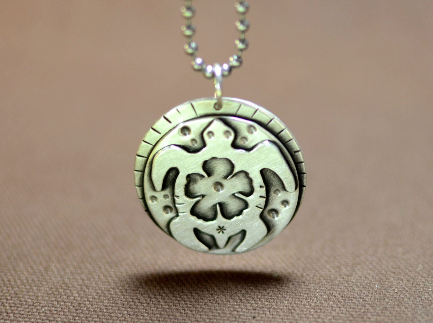Sea turtle necklace with hibiscus flower in sterling silver