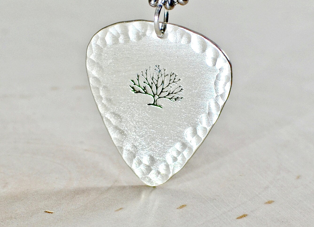 Sterling silver guitar pick necklace with a tree of life