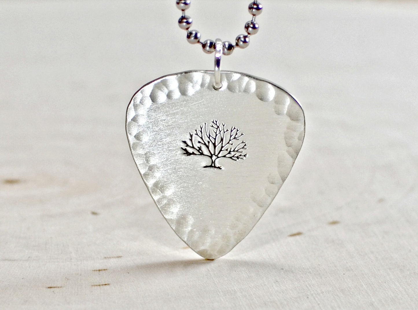 Sterling silver guitar pick necklace with a tree of life