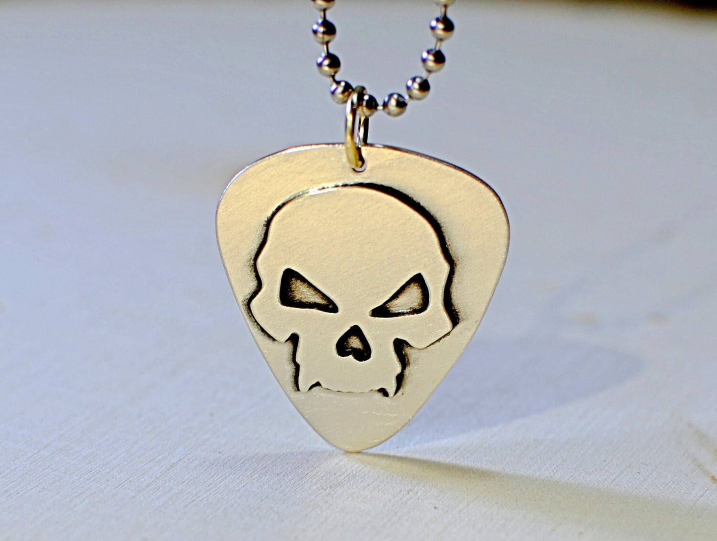 Skull design on sterling silver guitar pick for a bad ass guitarist