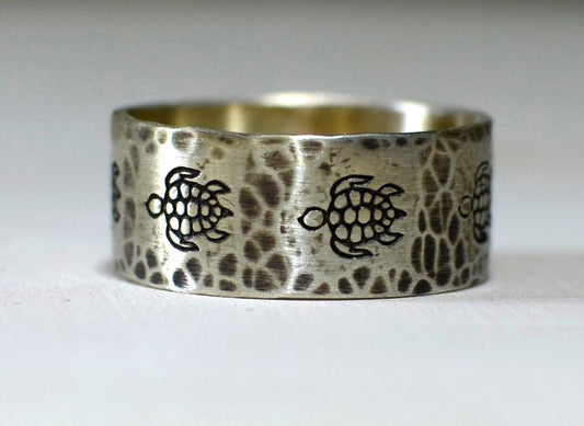 Sterling silver ring with rustic sea turtles and hammered patterning