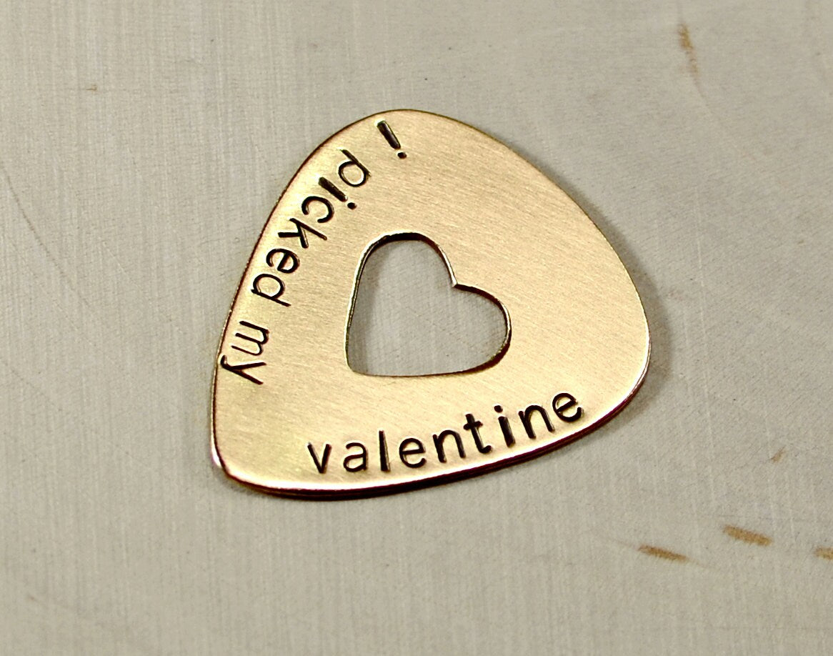 Valentines Day bronze guitar pick with a heart and message of love