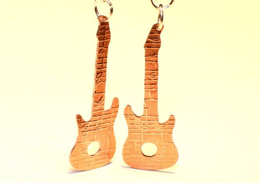 Copper guitar shaped earrings with music notes