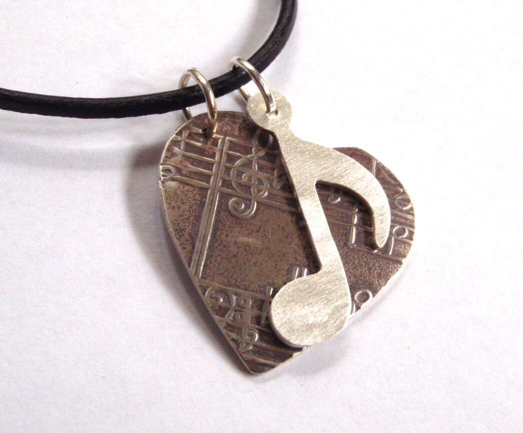 Silver heart with music notes necklace on a black leather cord