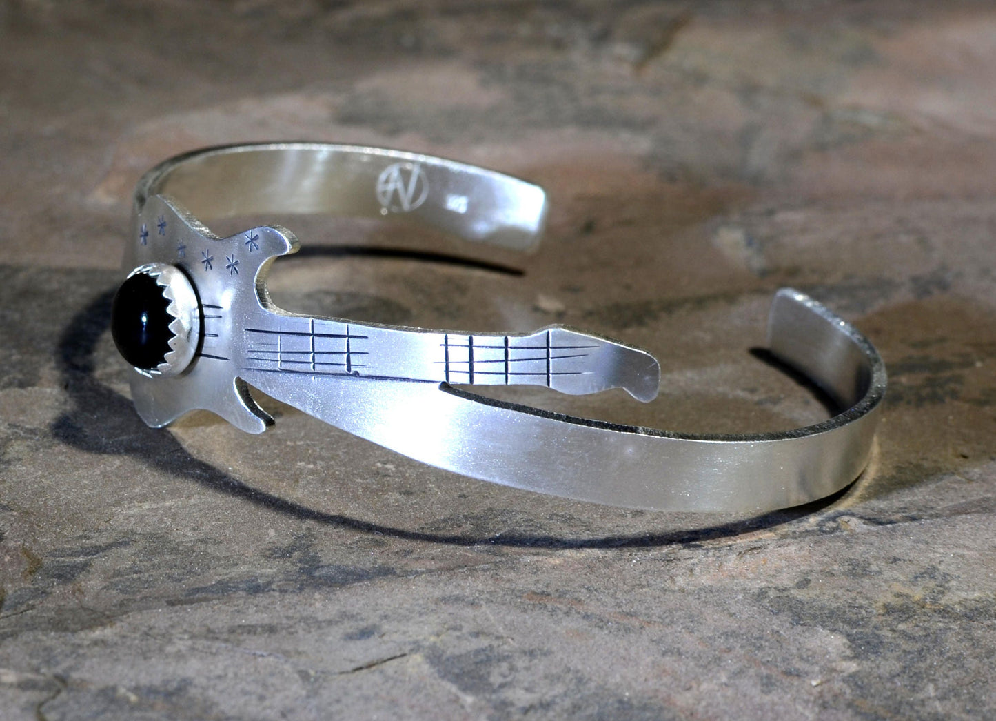 Sterling silver guitar bracelet with musical inspiration and black onyx gemstone