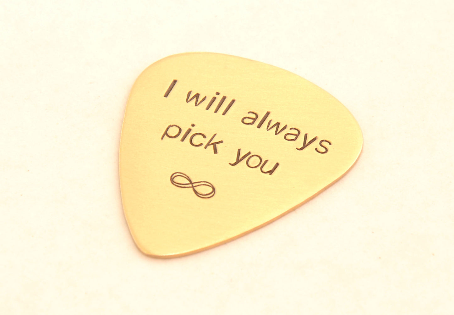 I will always pick you to infinity stamped on a bronze guitar pick