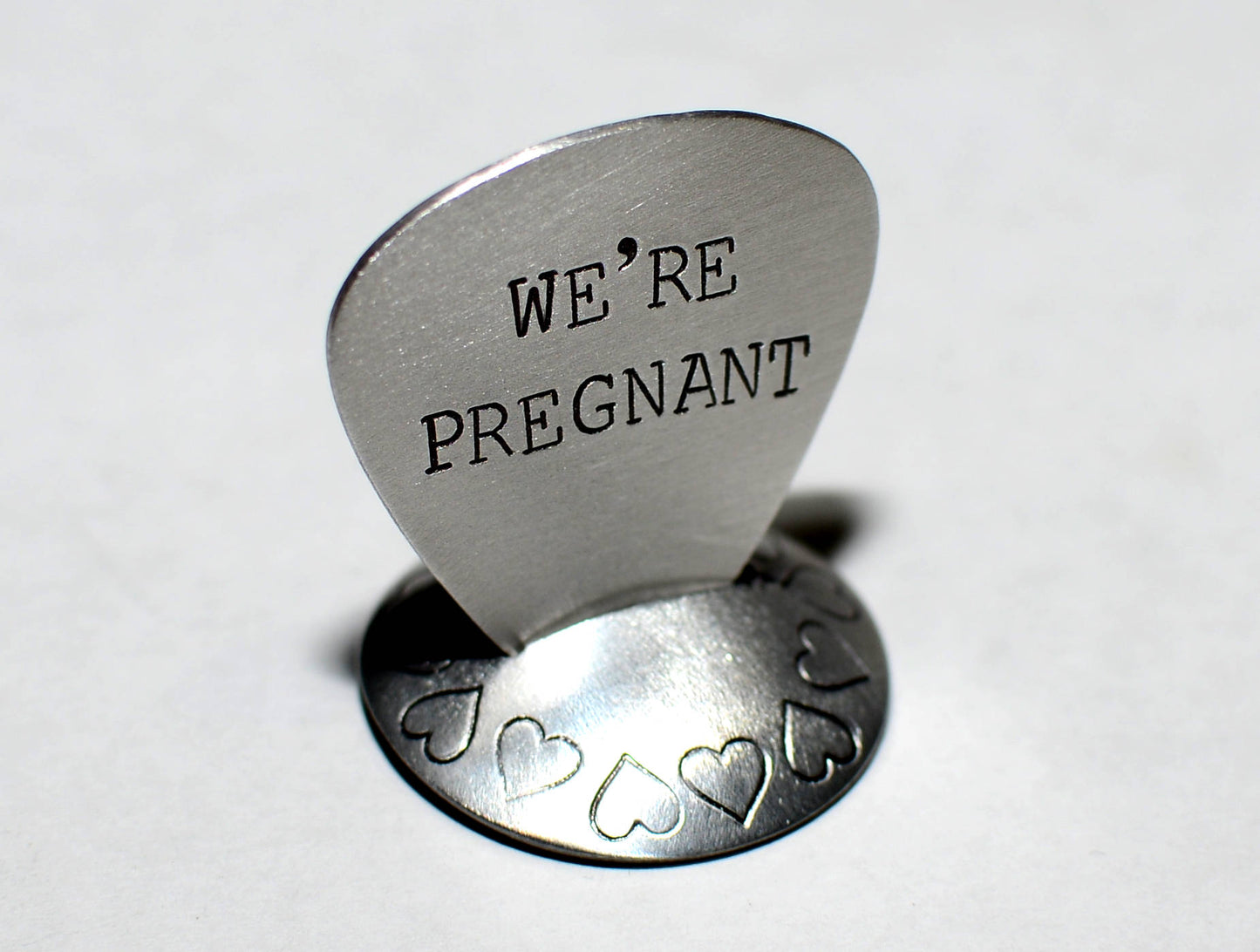 We’re Pregnant Guitar Pick for a Rocking Surprise in your choice of metals