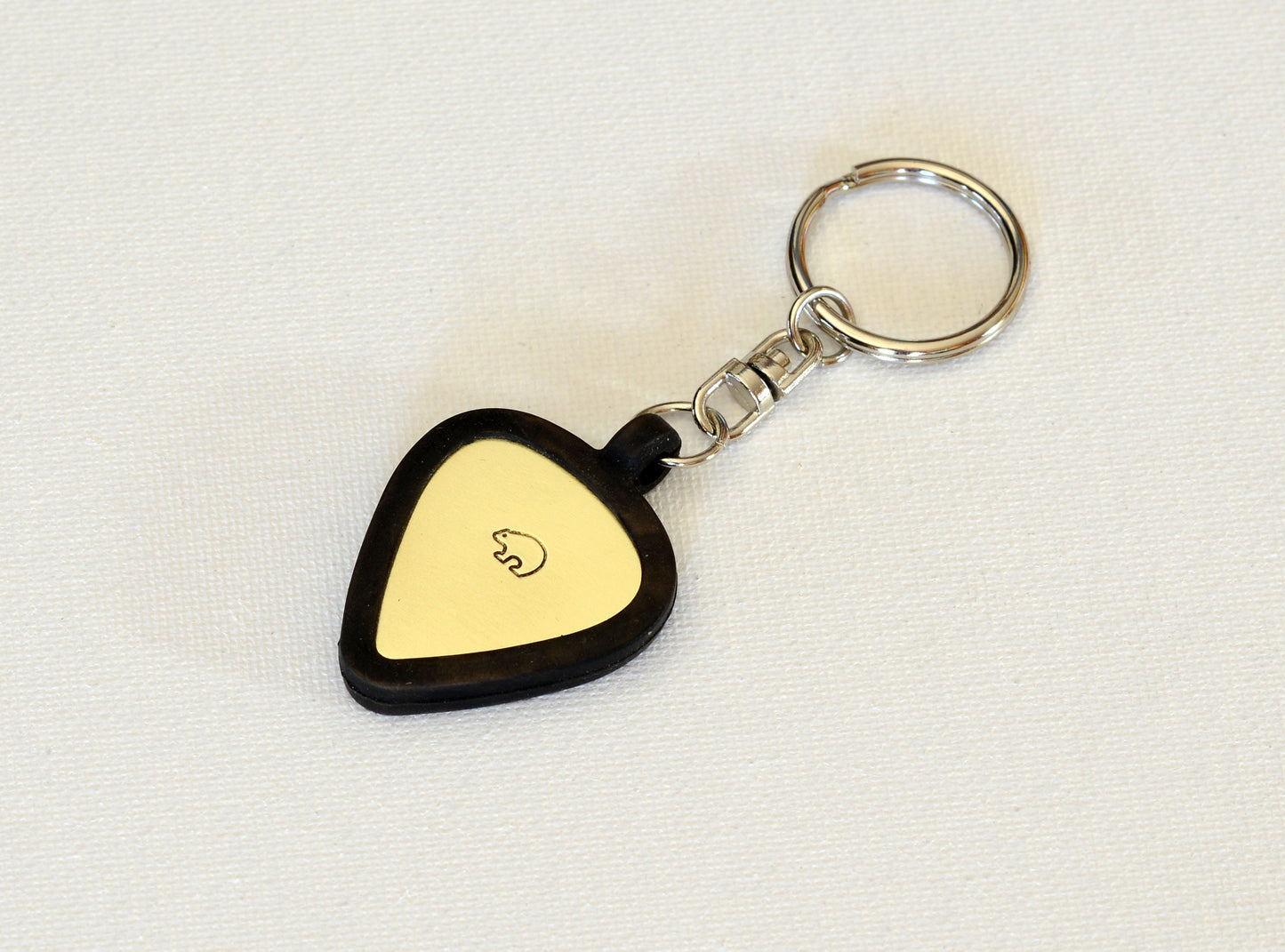 Brass guitar pick and a rubber guitar pick holder keychain