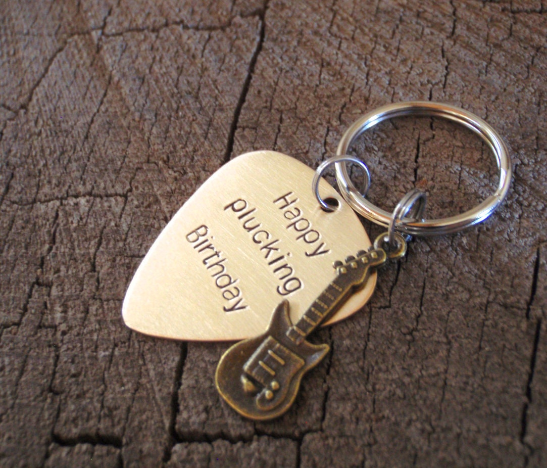 Guitar themed keychain based on a bronze guitar pick and a small brass guitar charm