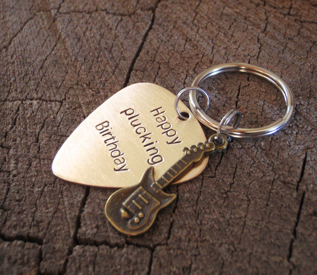 Guitar themed keychain based on a bronze guitar pick and a small brass guitar charm
