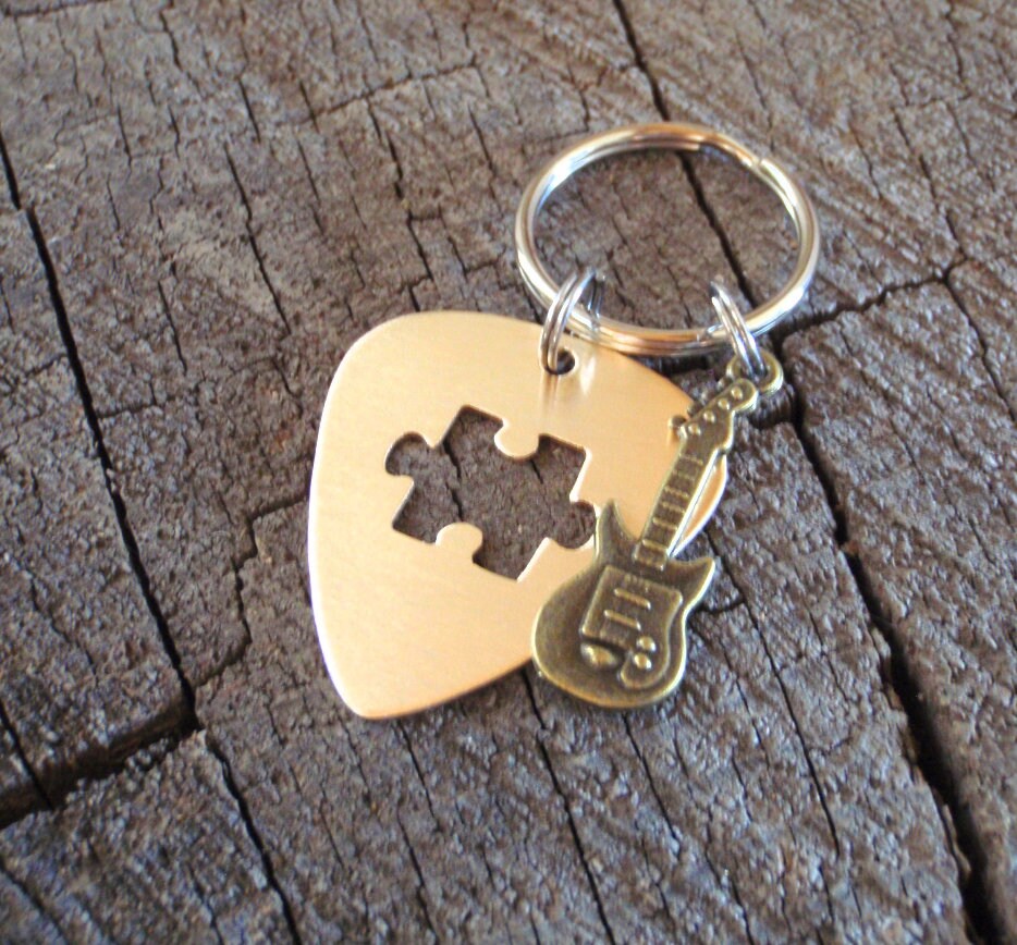 Guitar pick key ring with cutout puzzle piece in bronze and brass guitar charm