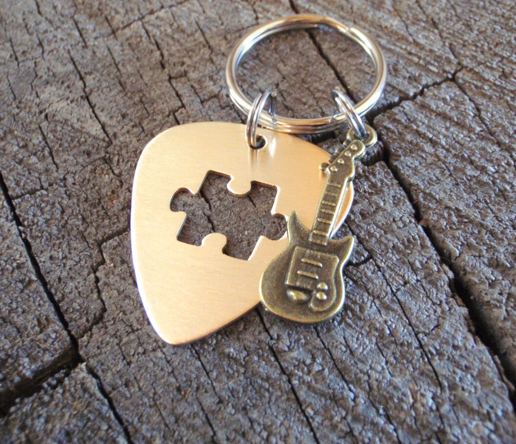 Guitar pick key ring with cutout puzzle piece in bronze and brass guitar charm
