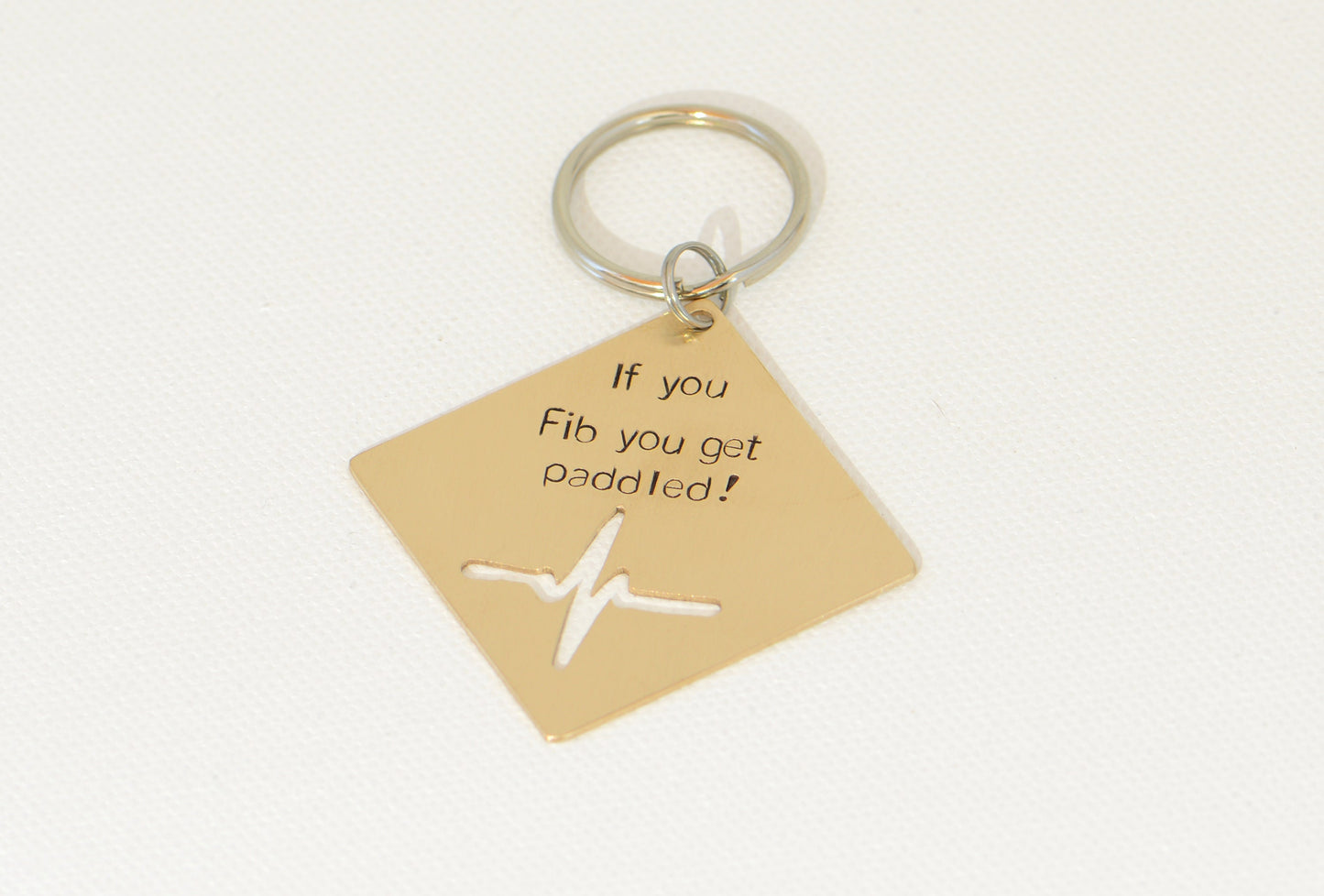 If you Fib you get paddled bronze key chain with heartbeat