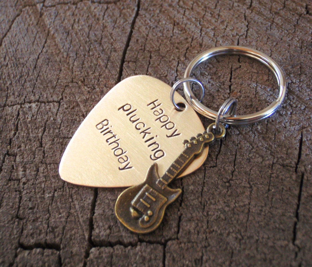 Guitar themed keychain based on a bronze guitar pick and a small brass guitar charm