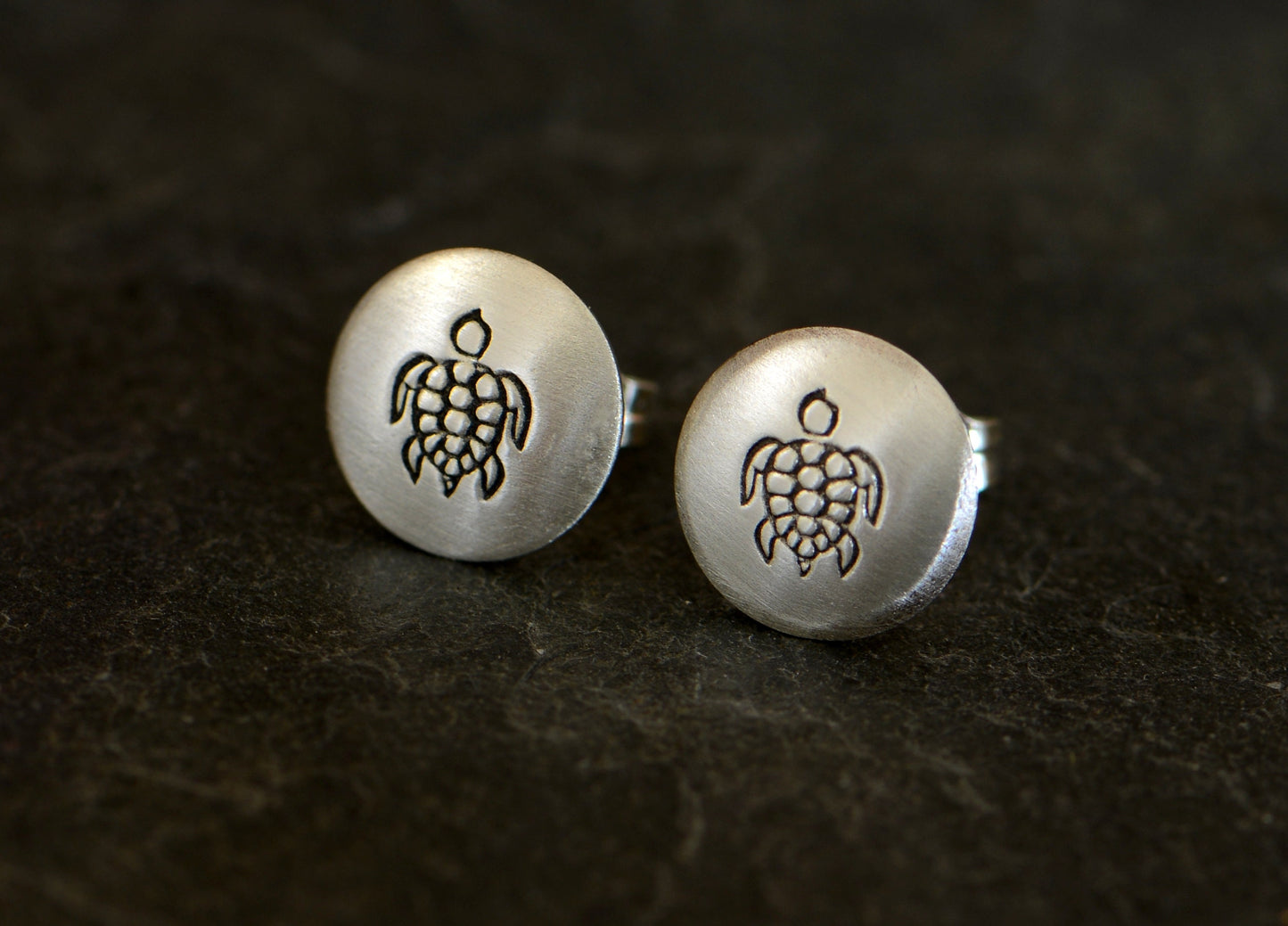 Button style earrings with sea turtle designs in sterling silver