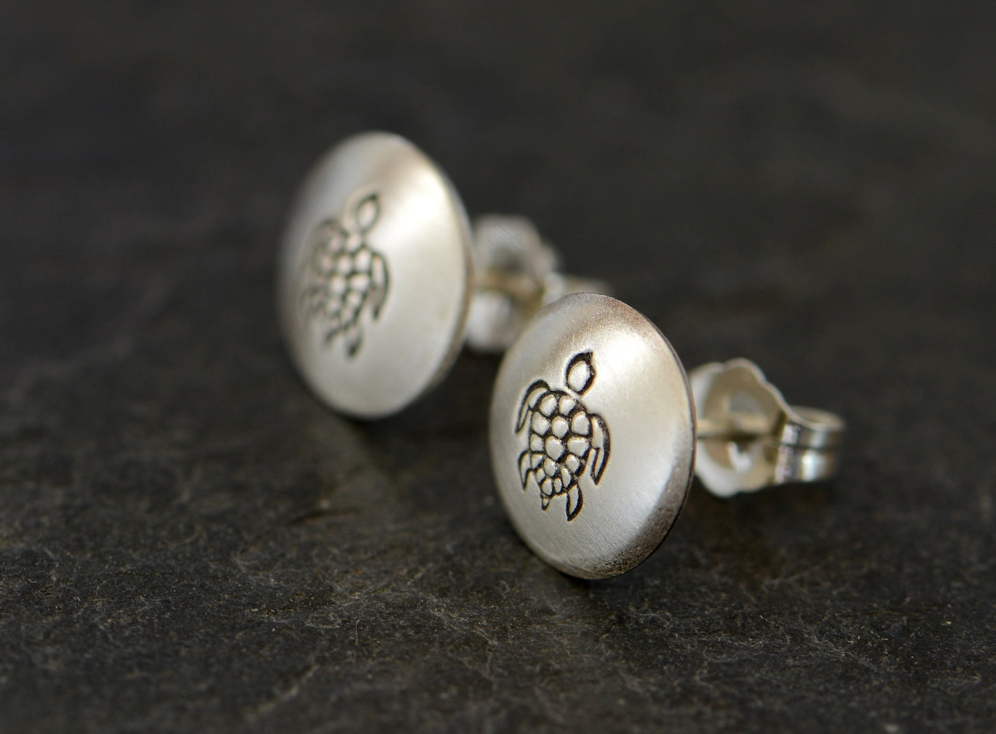 Button style earrings with sea turtle designs in sterling silver