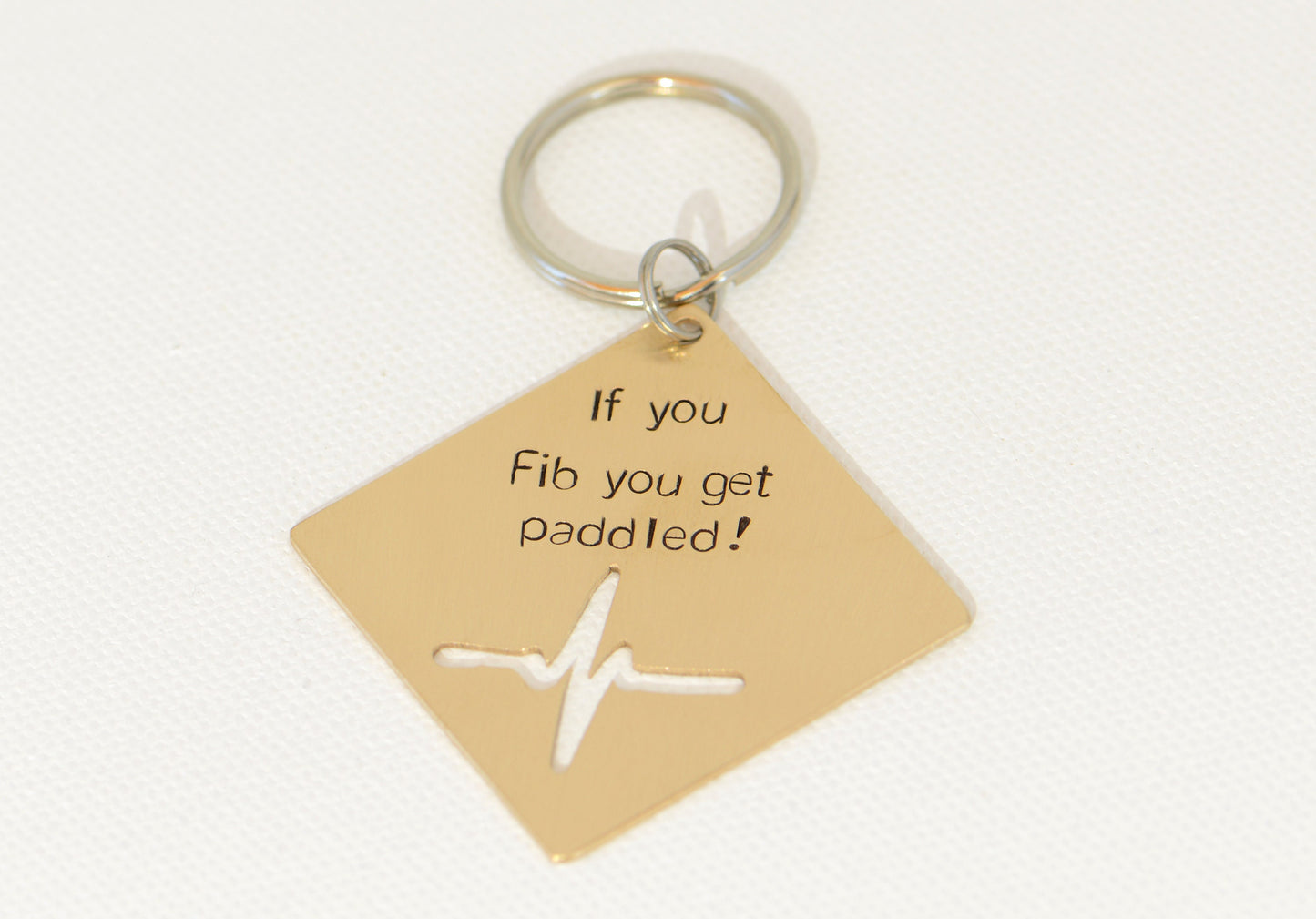 If you Fib you get paddled bronze key chain with heartbeat