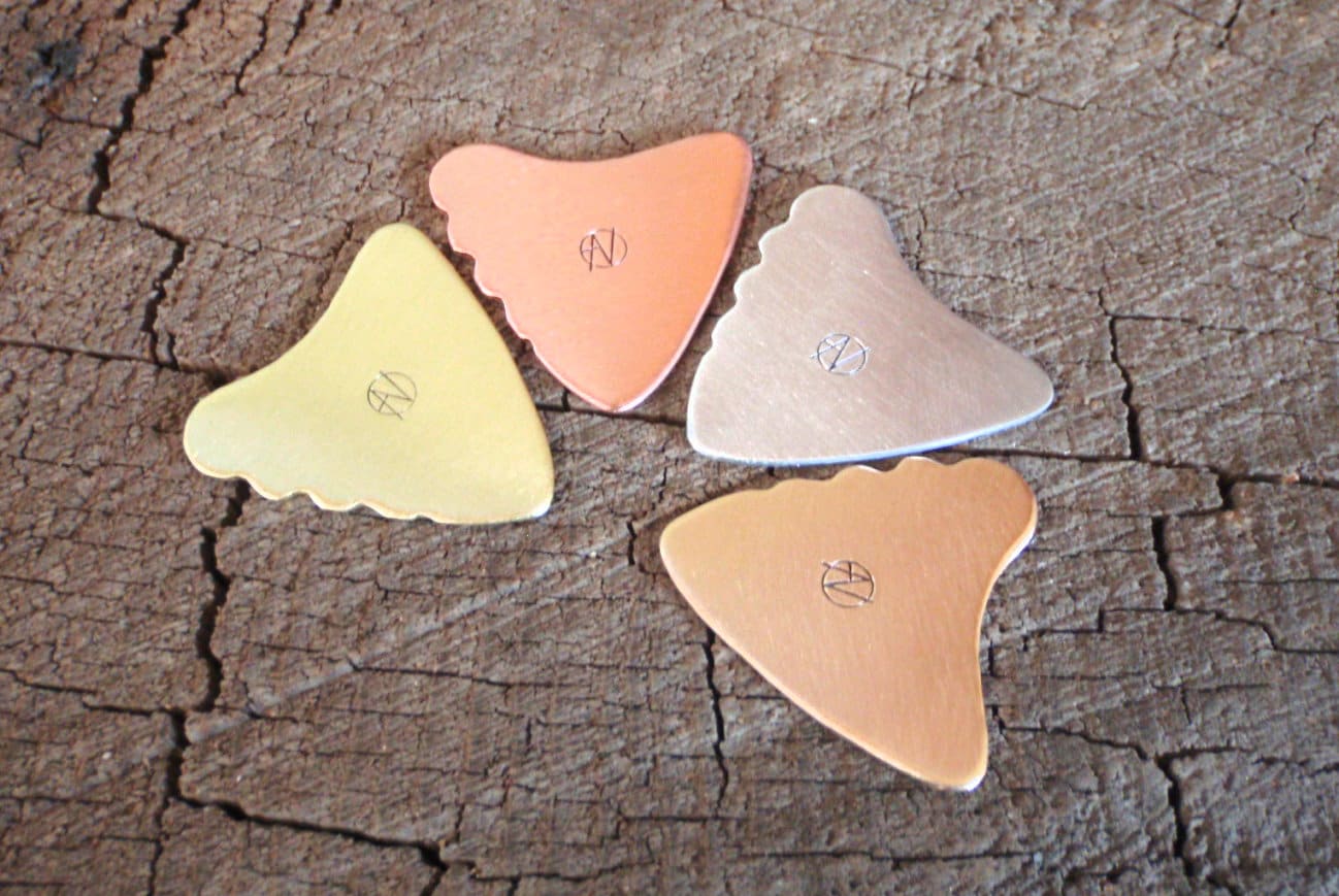Mixed bag of 4 different playable tooth shaped metal guitar picks