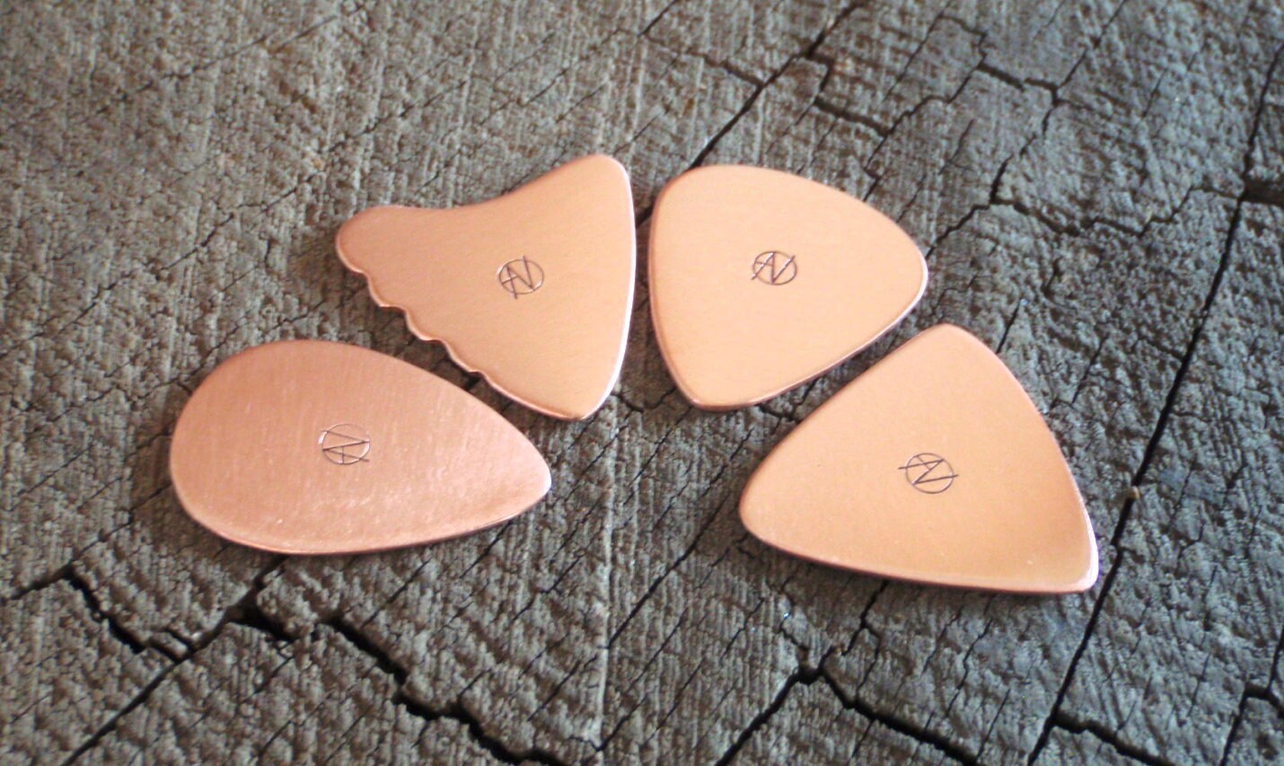 Grab bag of 4 playable copper guitar picks in various shapes and styles