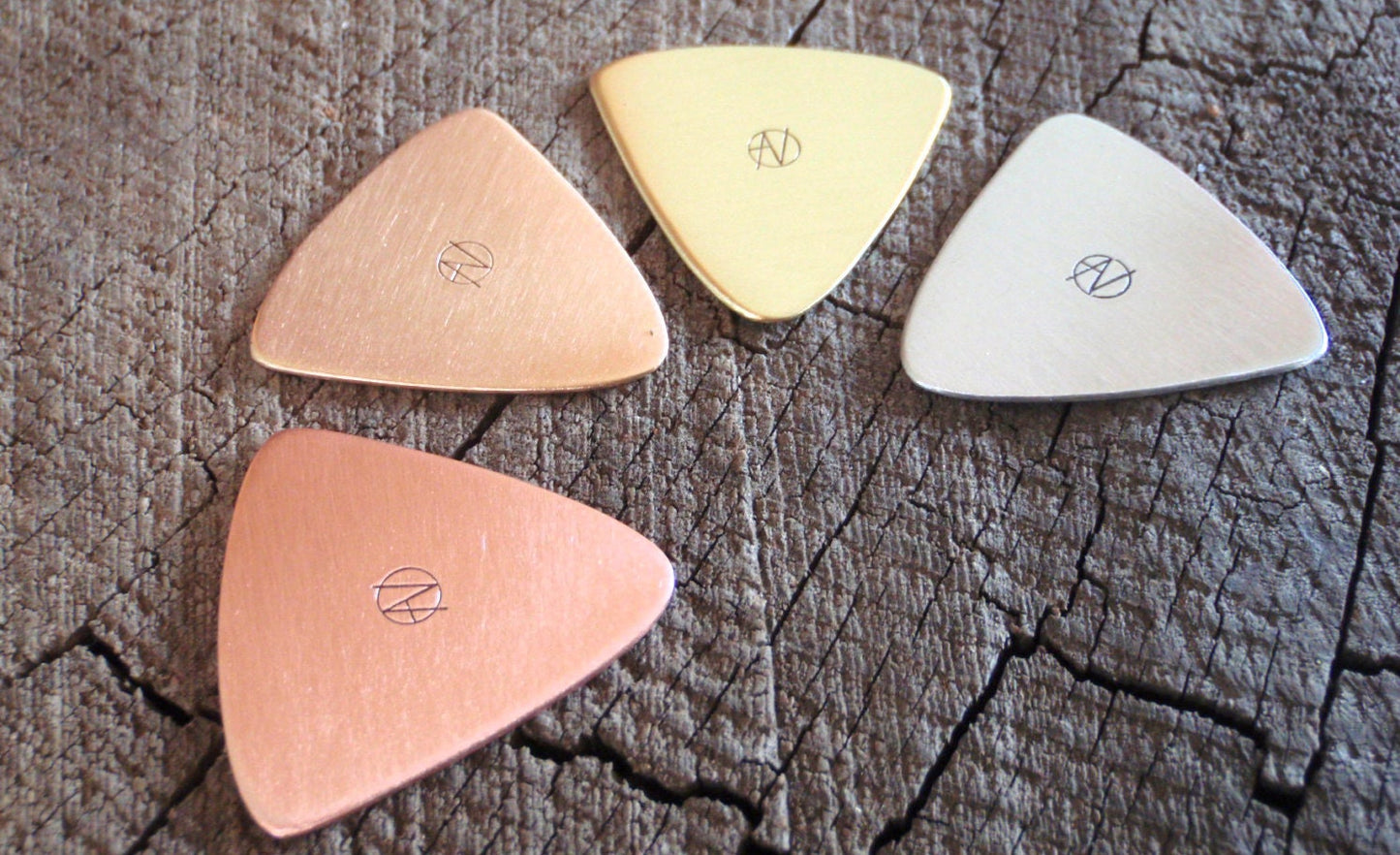 Mixed grab bag of playable metal guitar picks in triangular shape - copper , brass , bronze and aluminum - QTY 4