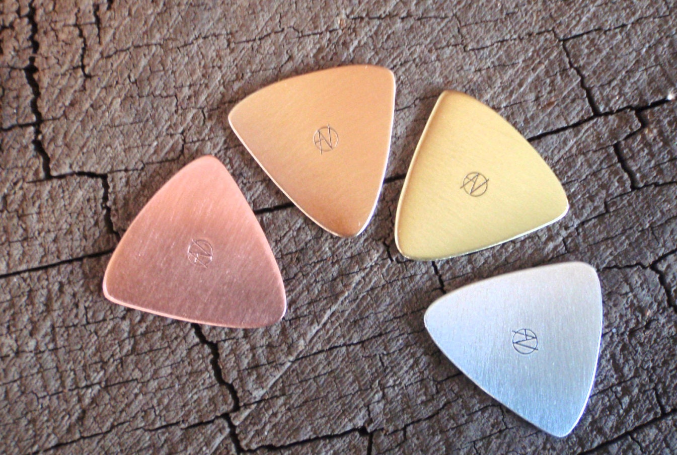 Mixed grab bag of playable metal guitar picks in triangular shape - copper , brass , bronze and aluminum - QTY 4