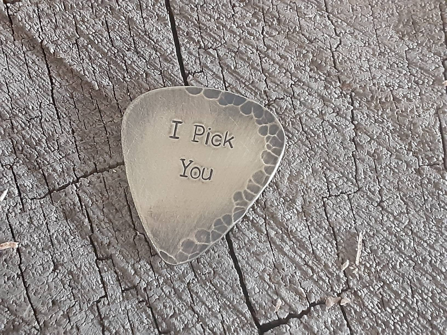 Brass guitar pick with a distressed finish