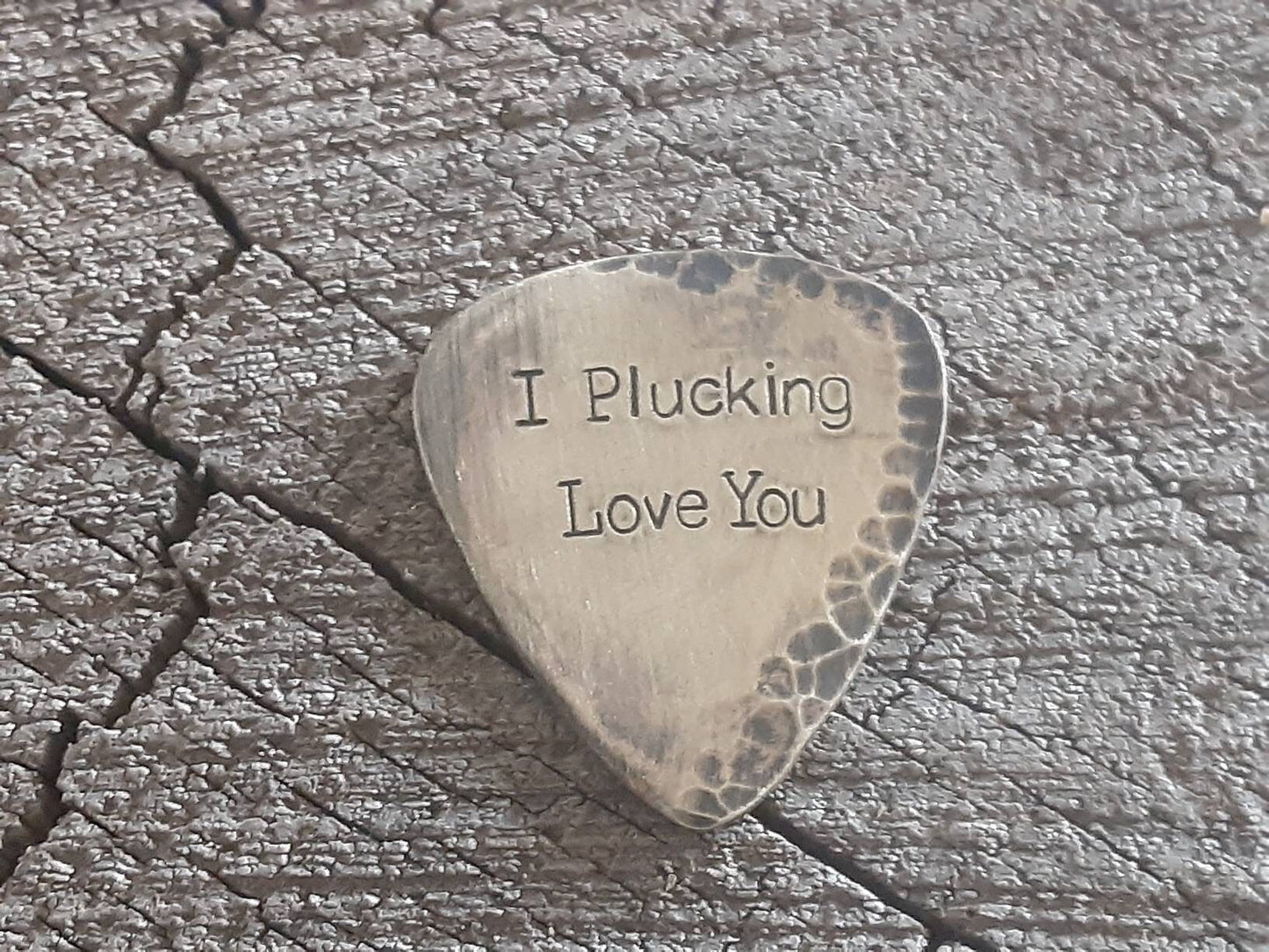 Distressed brass guitar pick for rustic styling