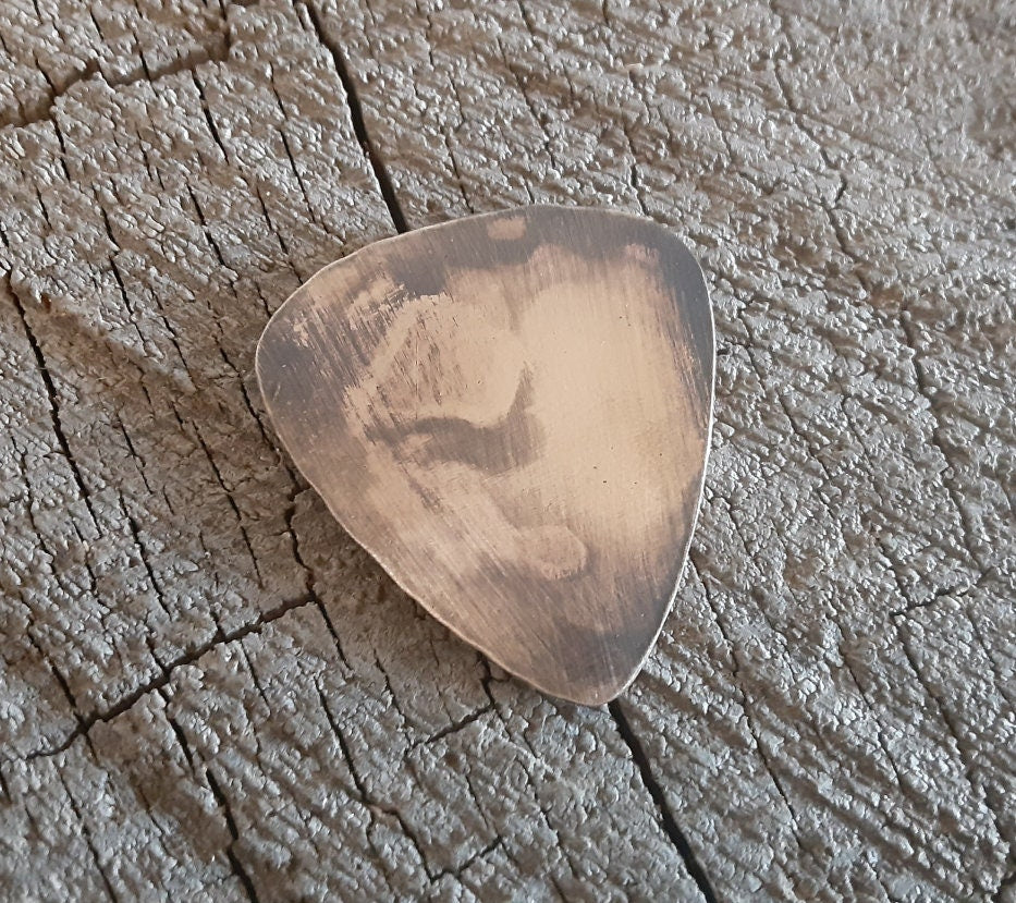 Distressed bronze guitar pick