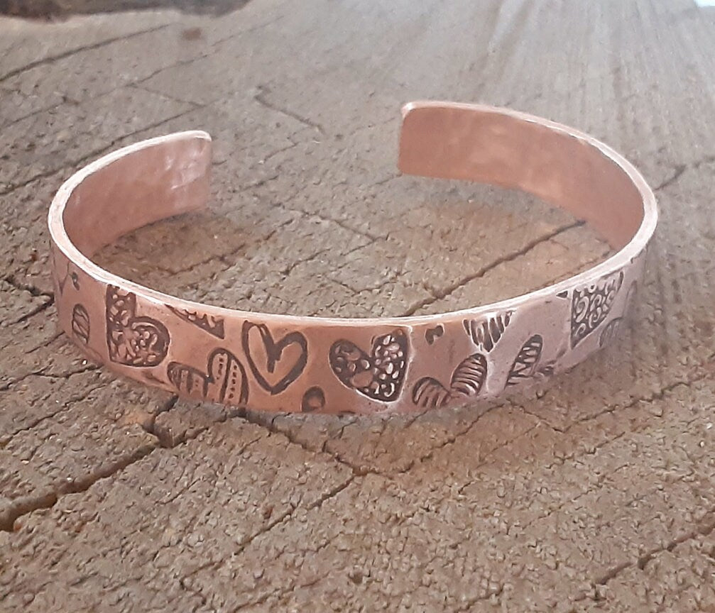 Copper cuff bracelet with hammed hearts
