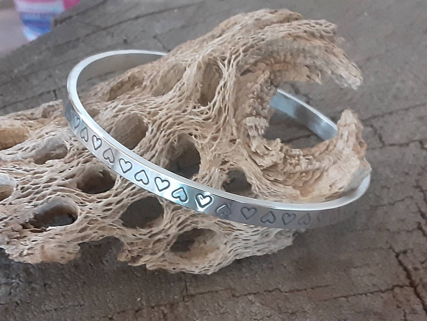 Thick and heavy sterling silver bangle with hearts