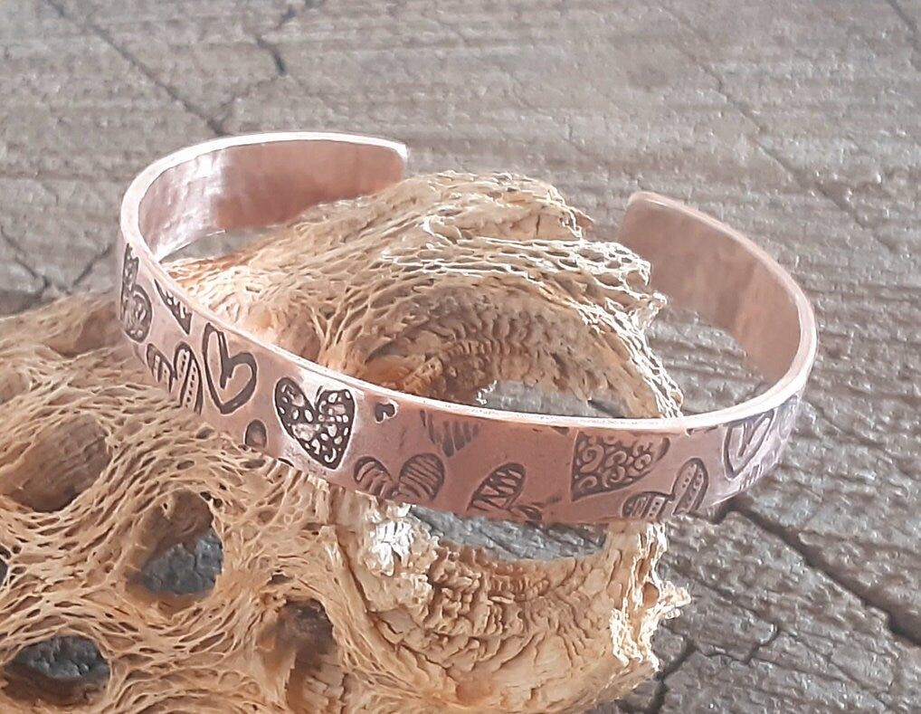 Copper cuff bracelet with hammed hearts