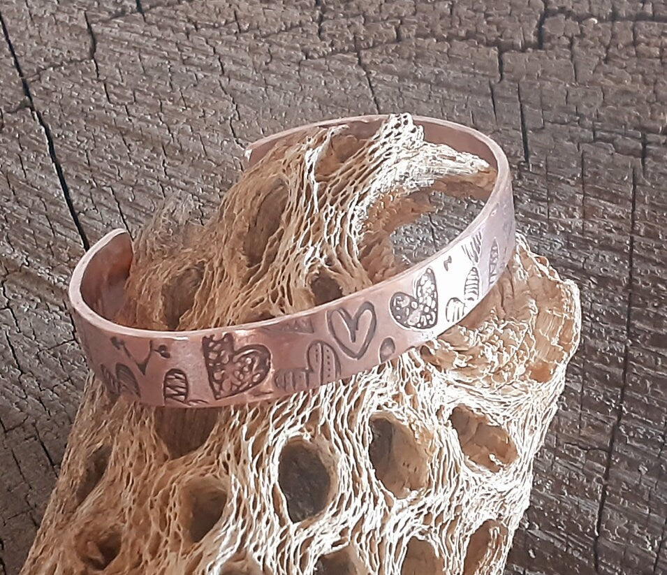 Copper cuff bracelet with hammed hearts