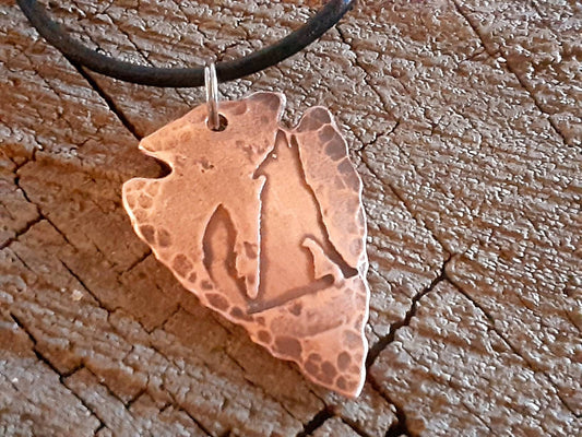 Men's copper arrowhead necklace with howling coyote and an adjustable leather cord