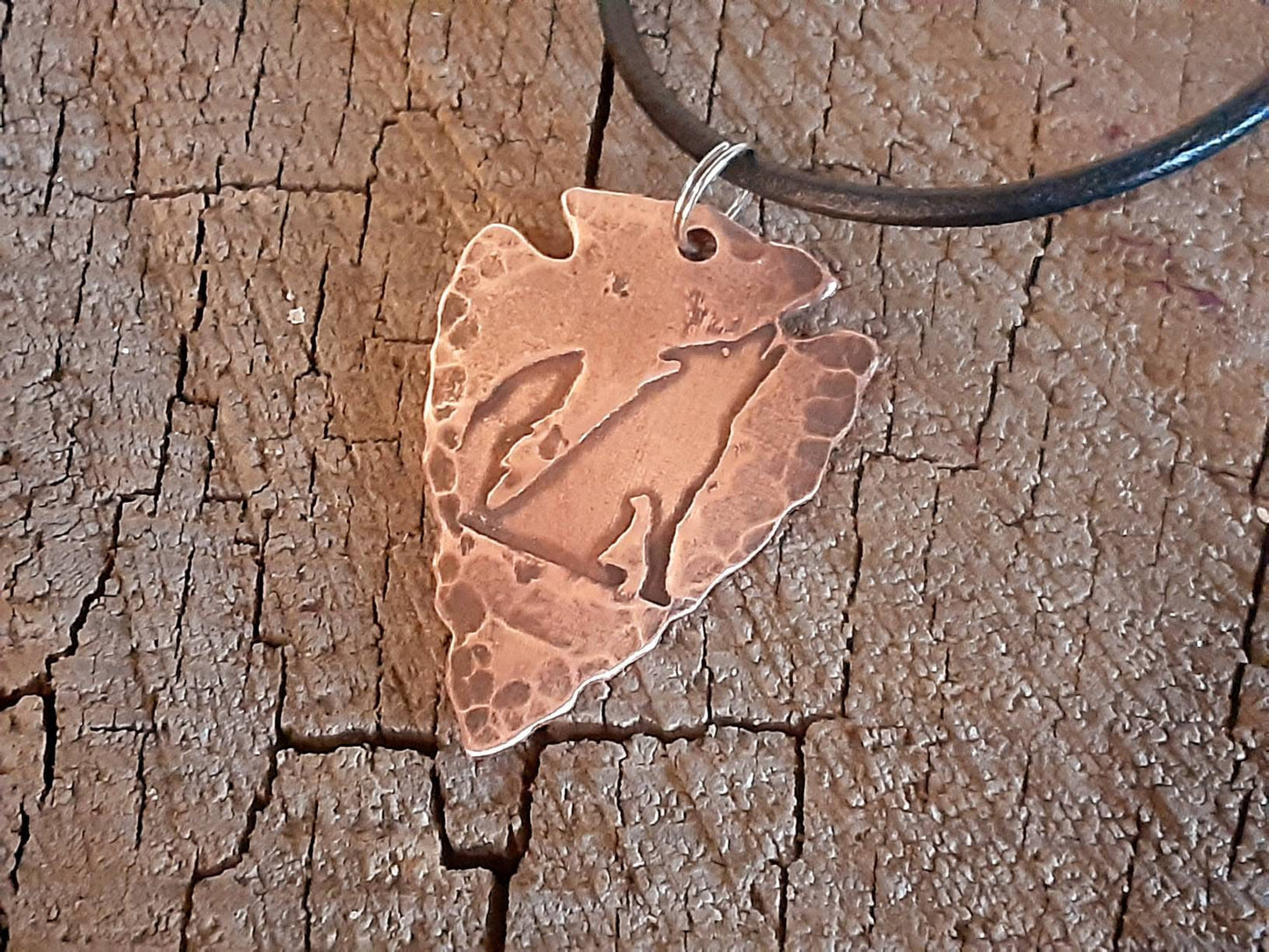 Men's copper arrowhead necklace with howling coyote and an adjustable leather cord