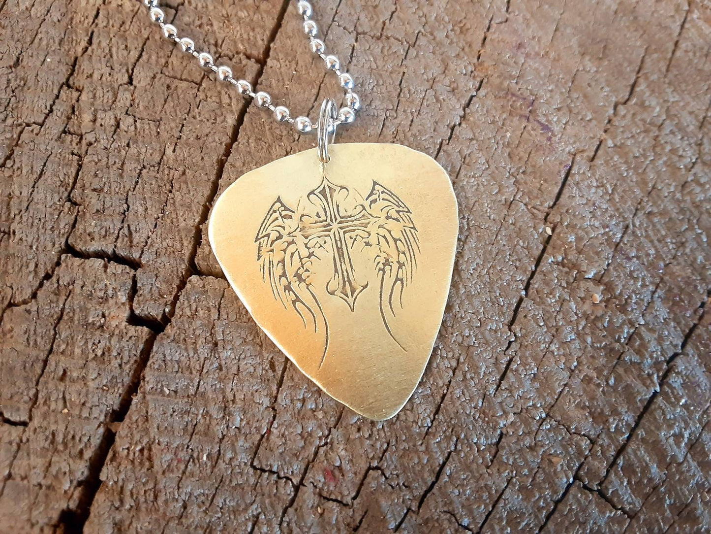 Winged cross on brass guitar pick necklace