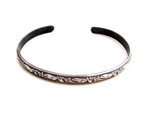 Sterling silver bracelet with floral design and patina