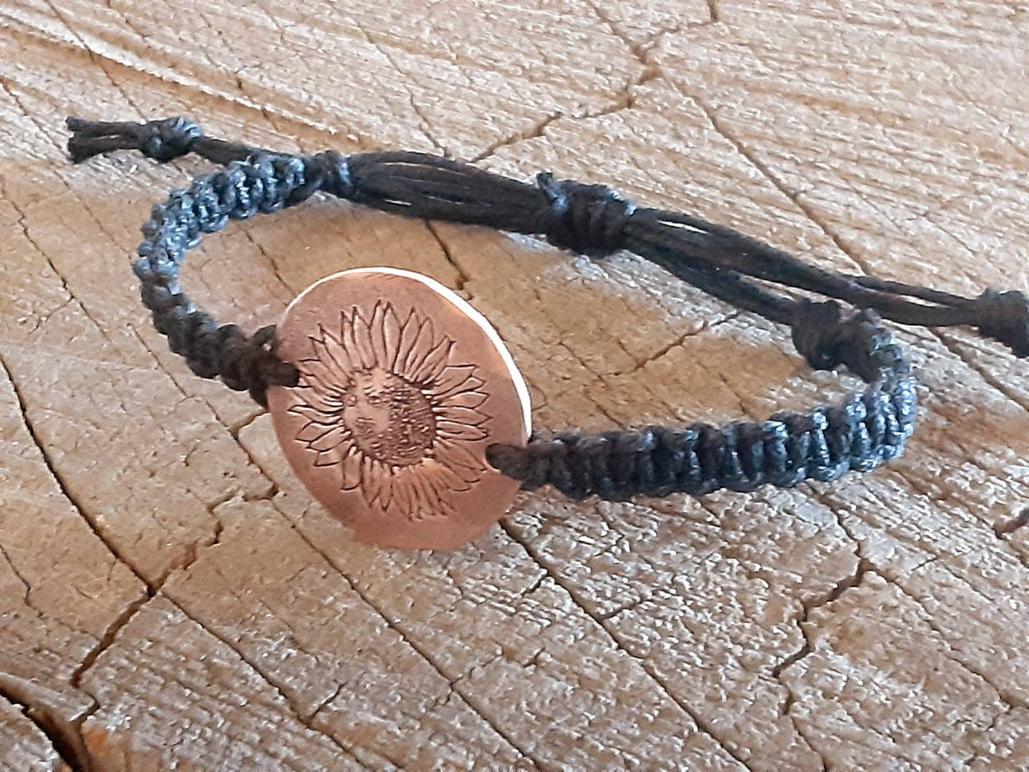Sunflower button bracelet in black hemp with copper tag