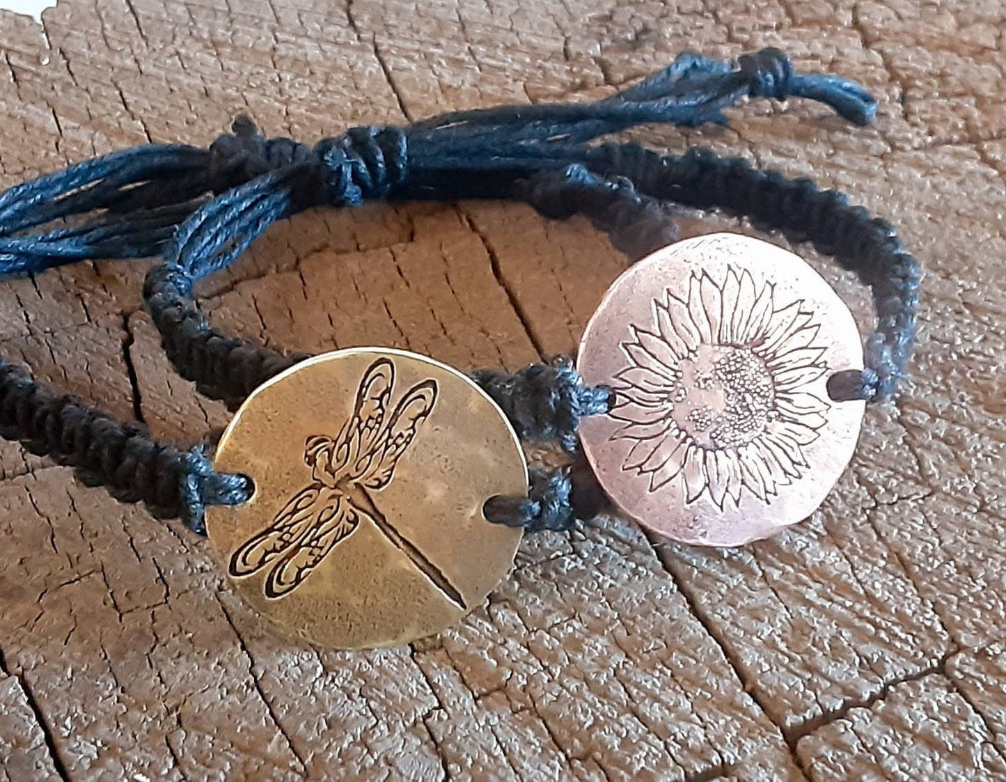 A pair of black hemp couples bracelets with sunflower and dragonfly designs