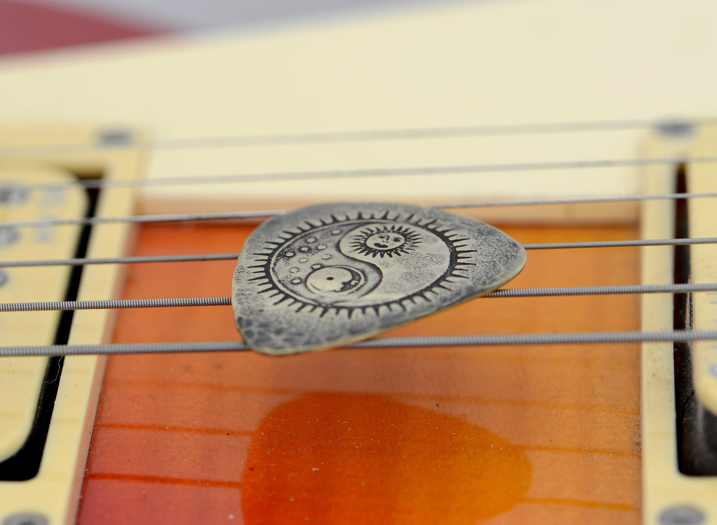 Yin Yang Sun and Moon on a Bronze Guitar Pick